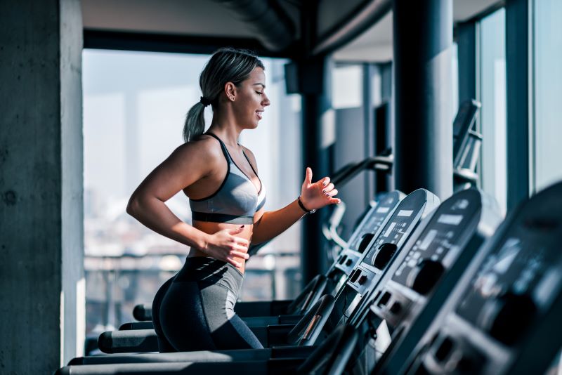 side-view-beautiful-muscular-woman-running-treadmill
