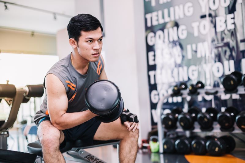 young-bodybuilder-is-exercising-by-lifting-dumbbell-gym
